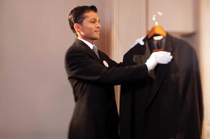 Butler combing a jacket