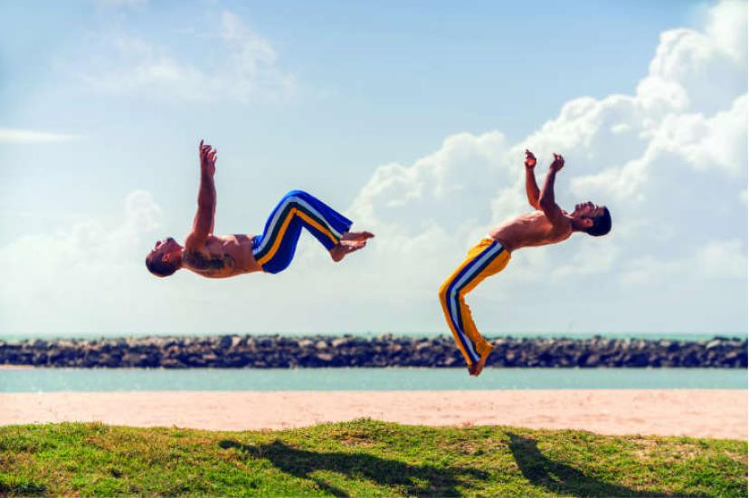 Two men practising capoeira