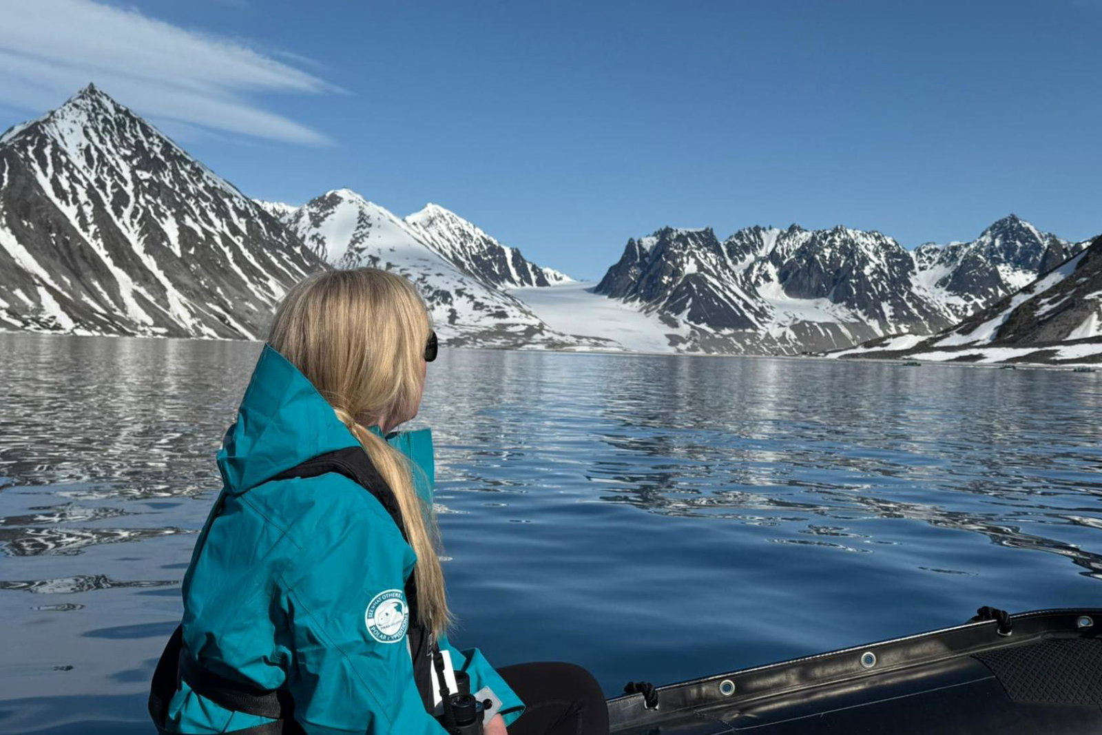 Rebecca Barnes rides on a Zodiac in Svalbard