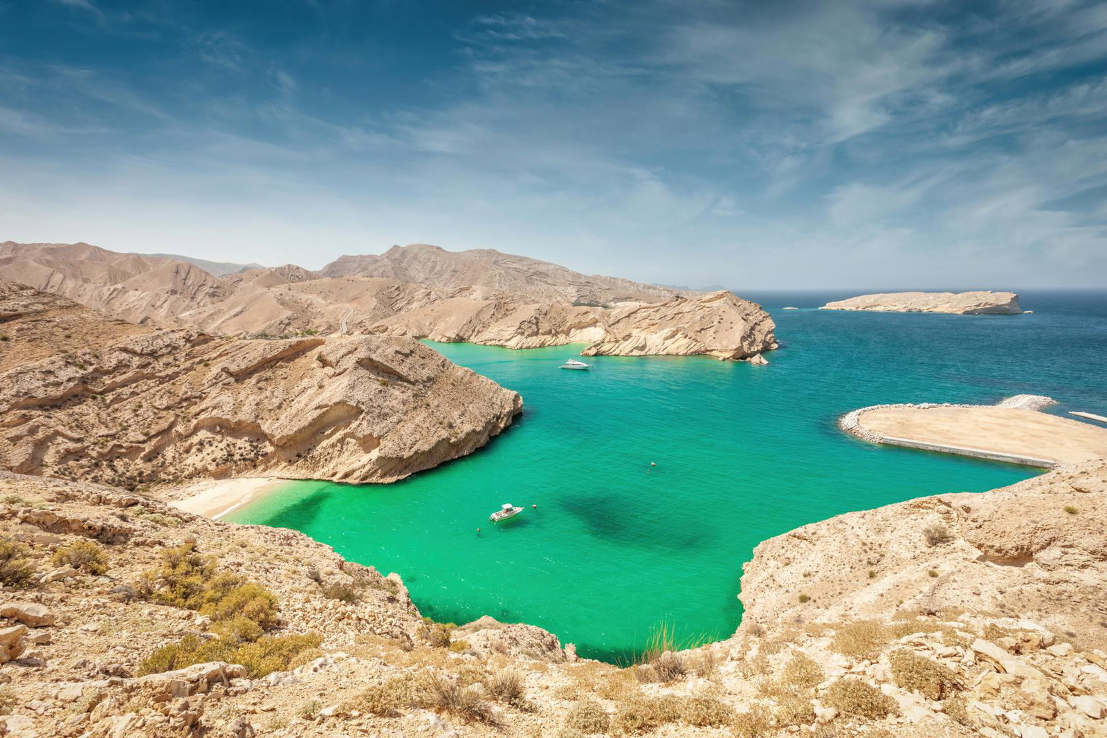View of mountainous coastline surrounding a turquoise lagoon