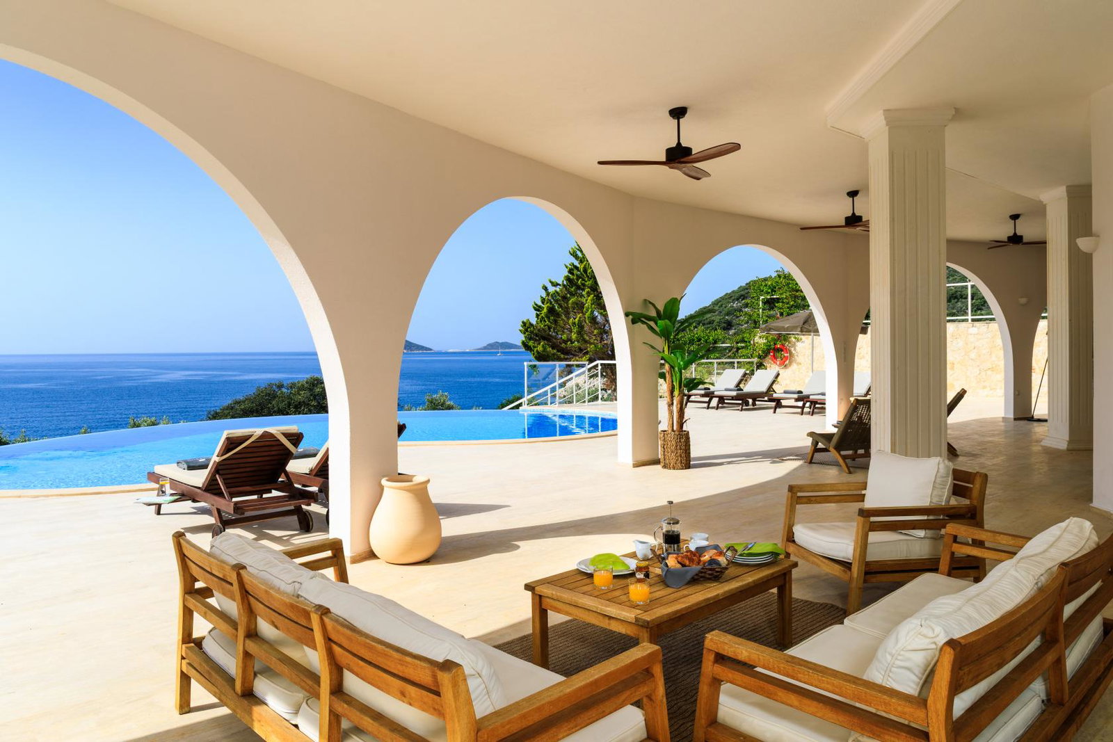 View from a villa in Kalkan, Turkey showing seating area, pool and sea view.