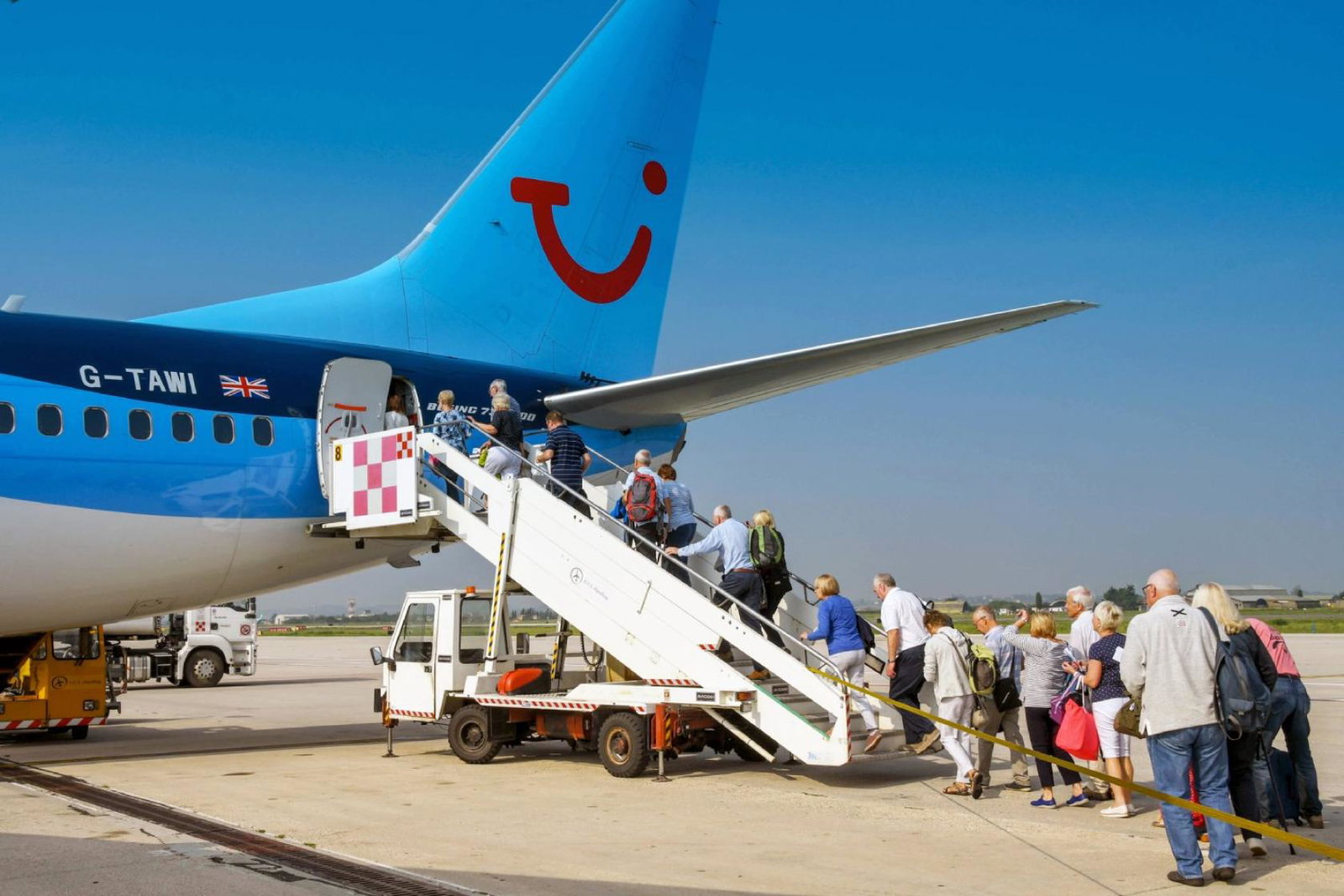 Passengers board a Tui aircraft