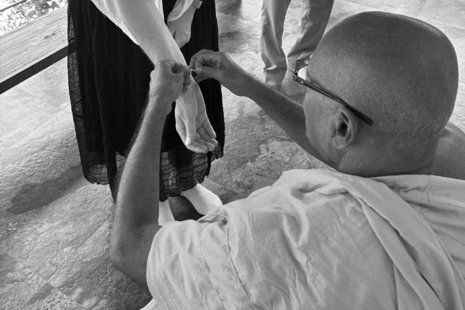 Caroline being blessed by monk