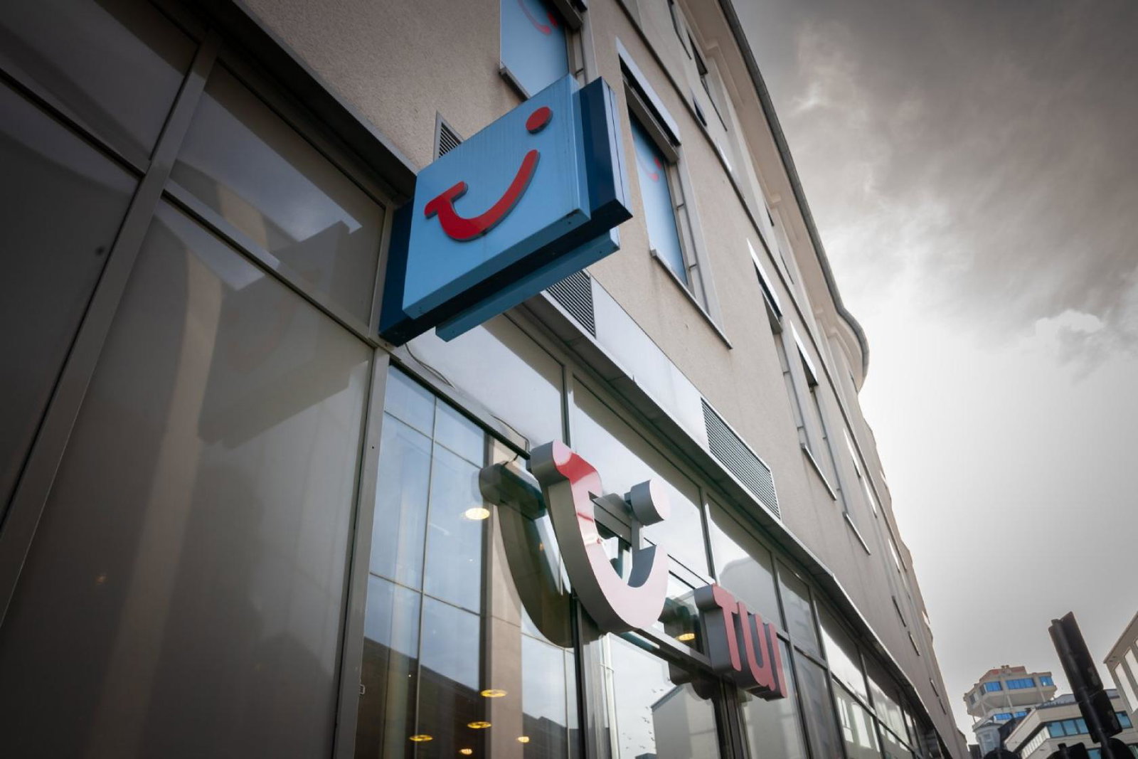 A tui shop pictured with the smile logo on the side of the building