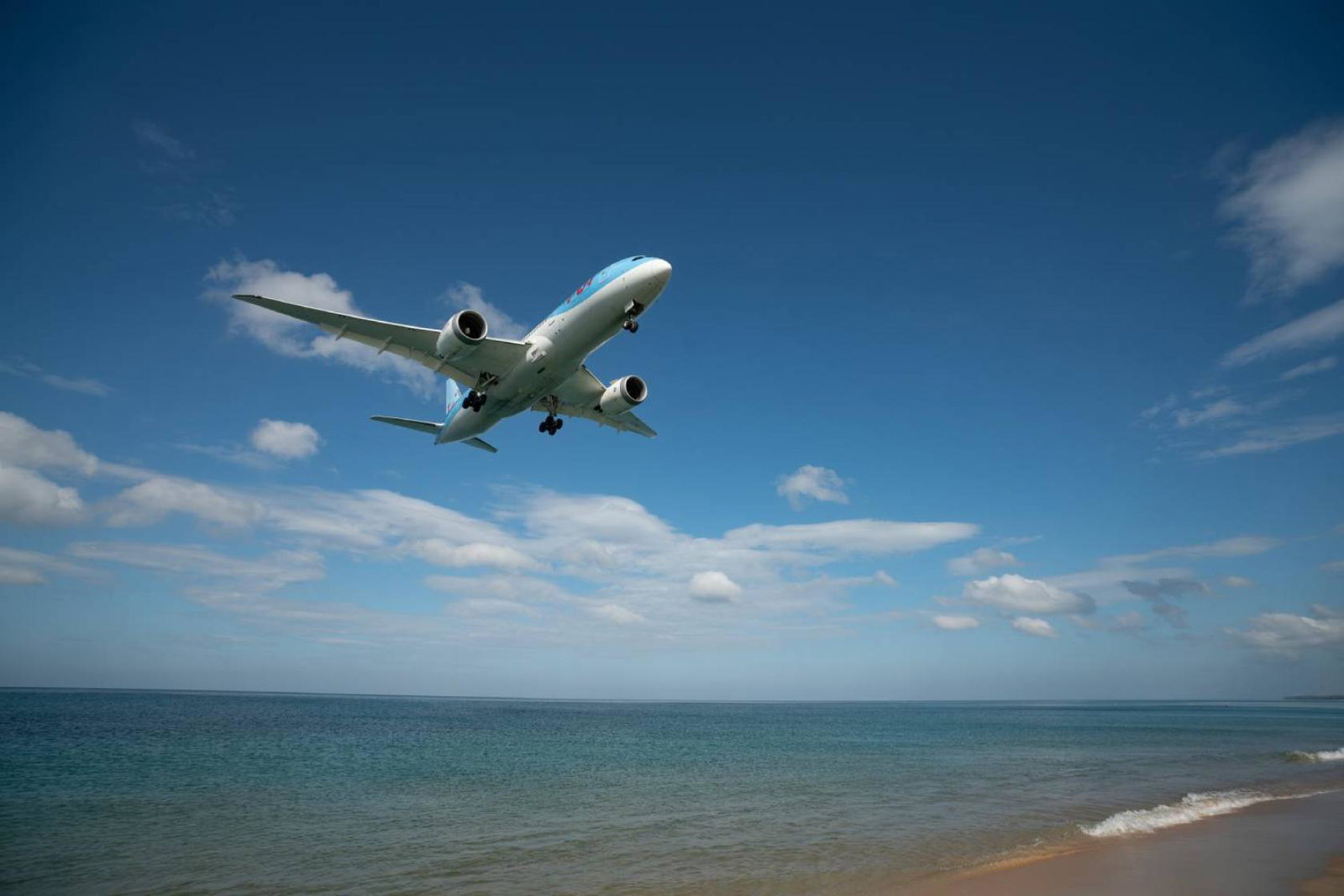 Tui plane flying over beach