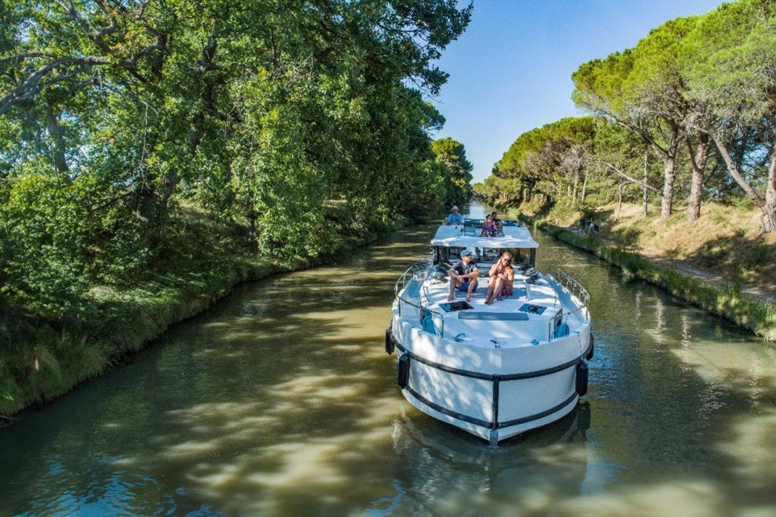 Travellers enjoy soaking up the sun on a river boat cruise