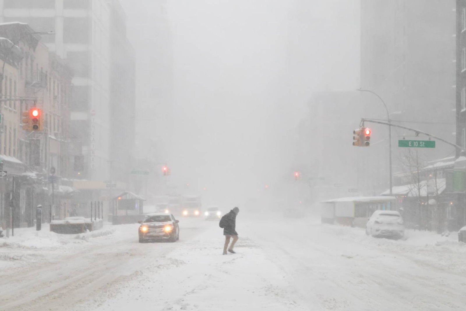 Lone walker crossing a New York street during a blizzard