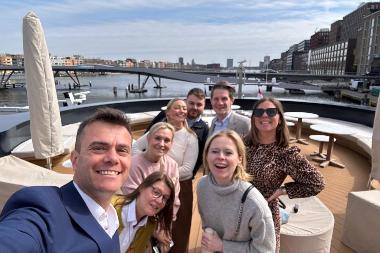 Group of people smiling on ship 