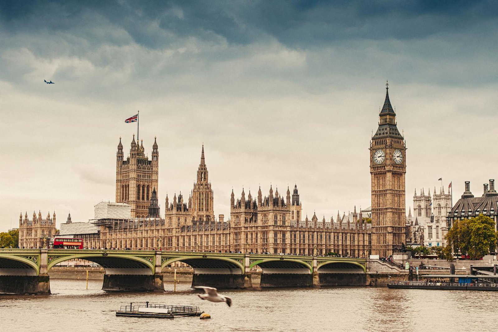 An aircraft flies over the UK parliament in London