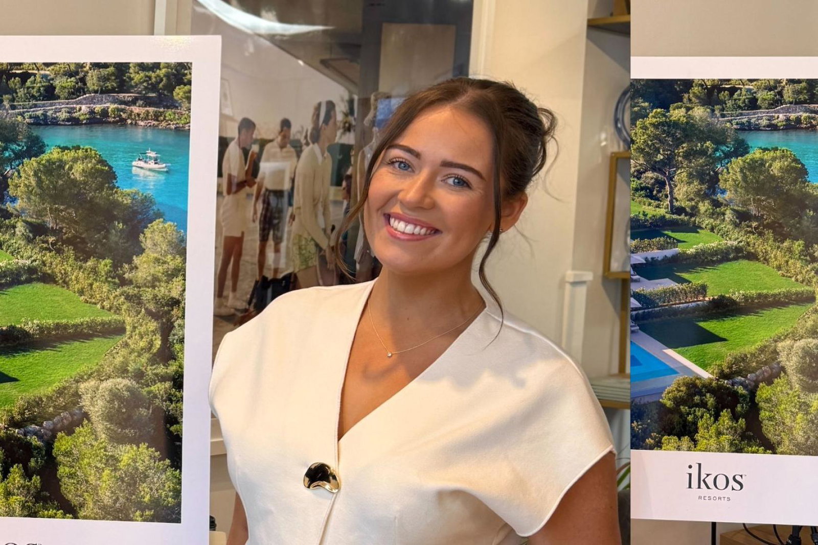 Brown haired woman smiling in white top 
