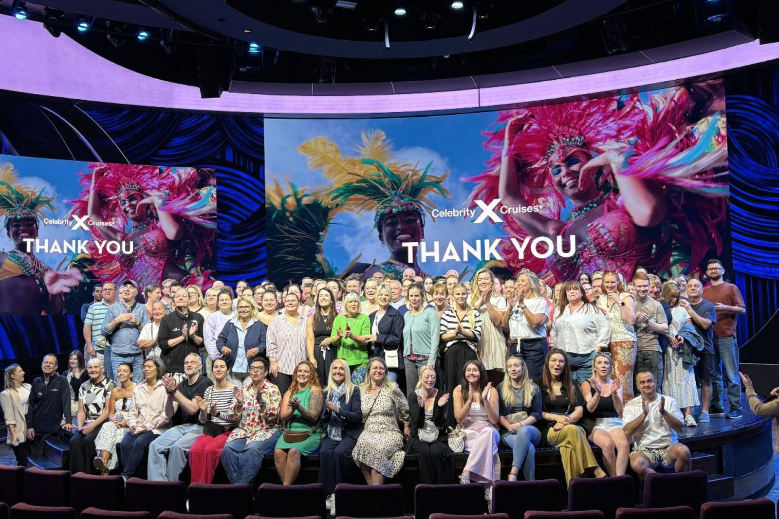 Hundreds of agents gather on stage for a group photo
