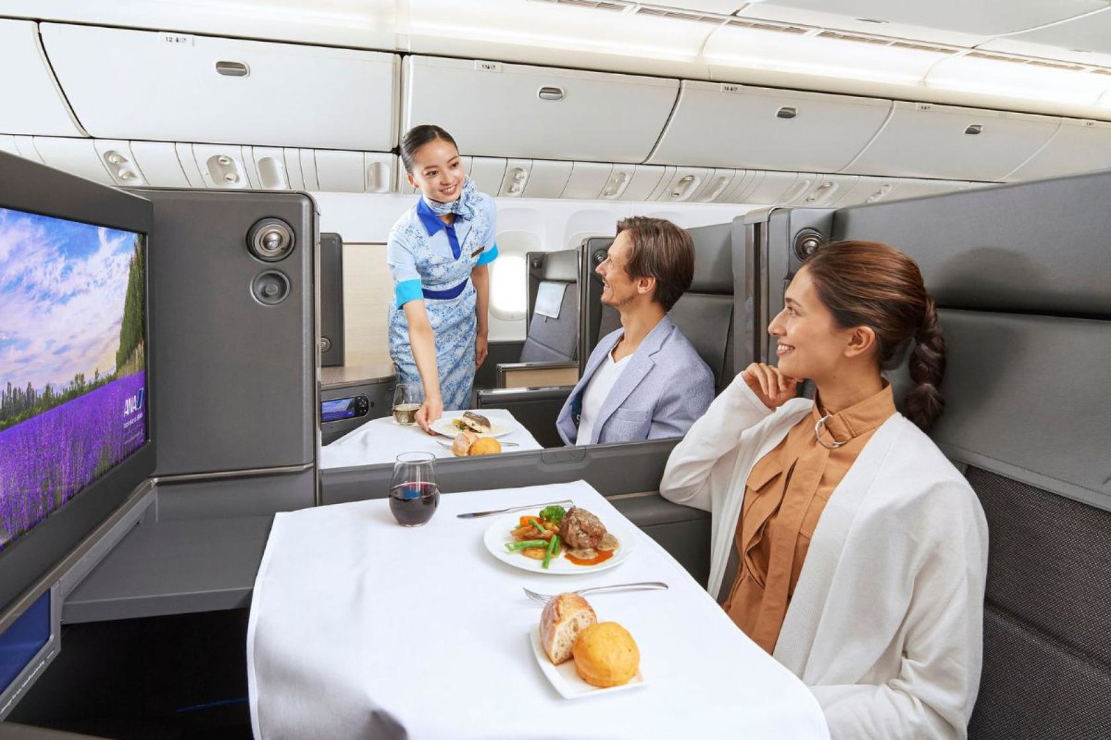Cabin crew attending two passengers on an ANA flight