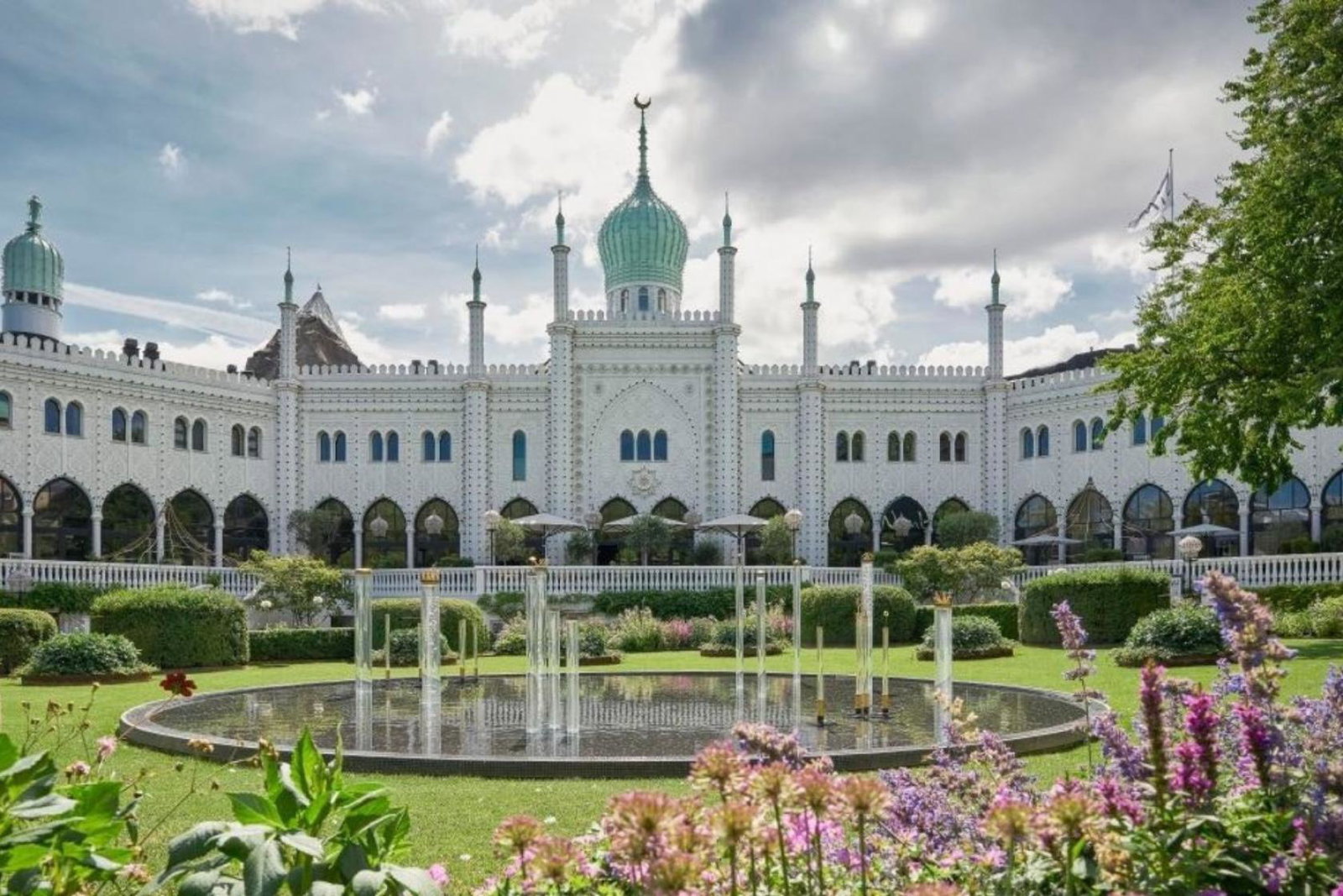 White palace-like hotel with green gardens 