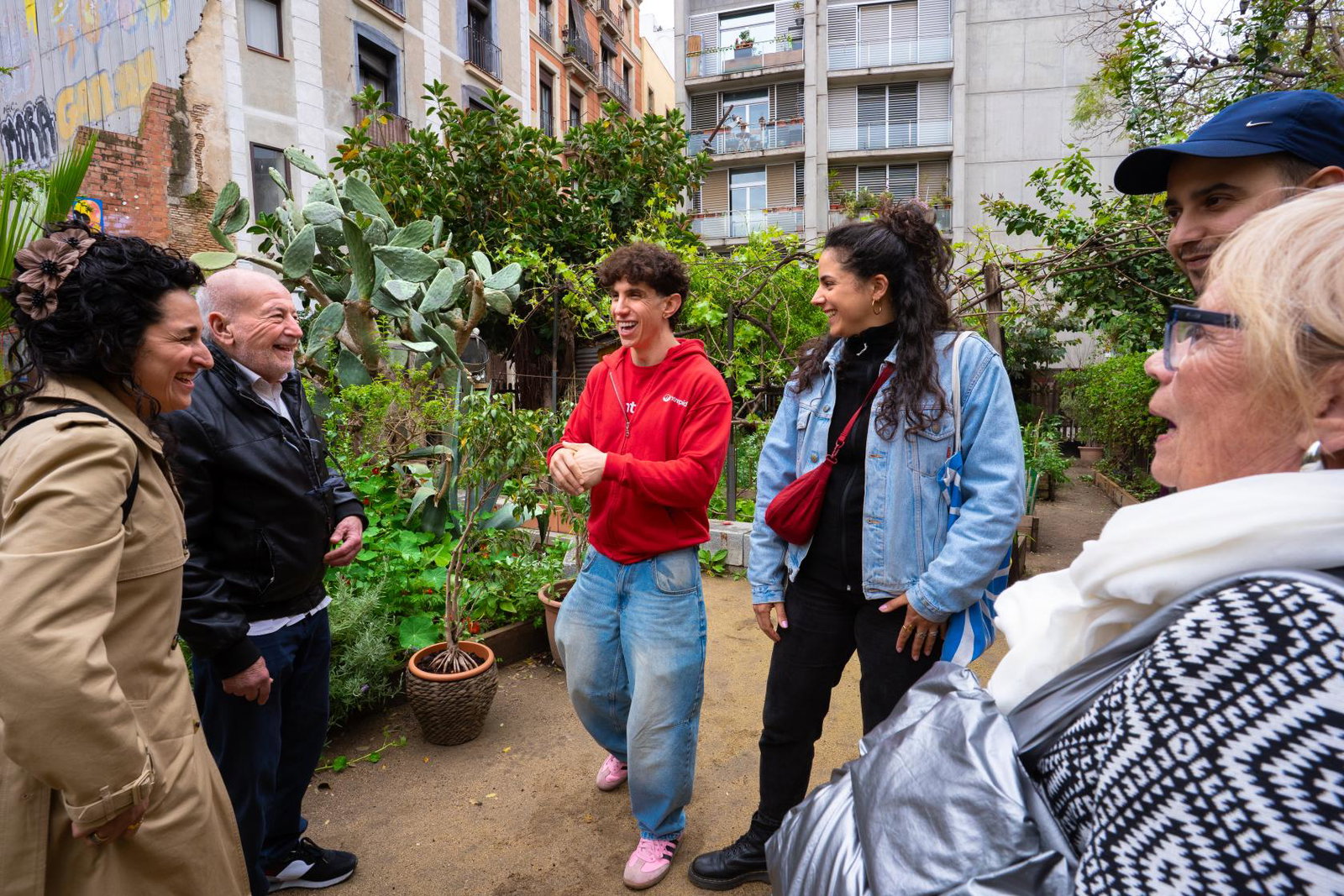 An Intrepid tour leader takes a multigenerational travel group through a lesser known neighbourhood in Barcelona, Spain