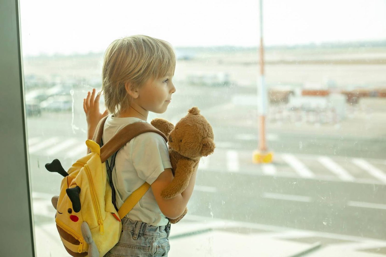 Child looking out of airport window
