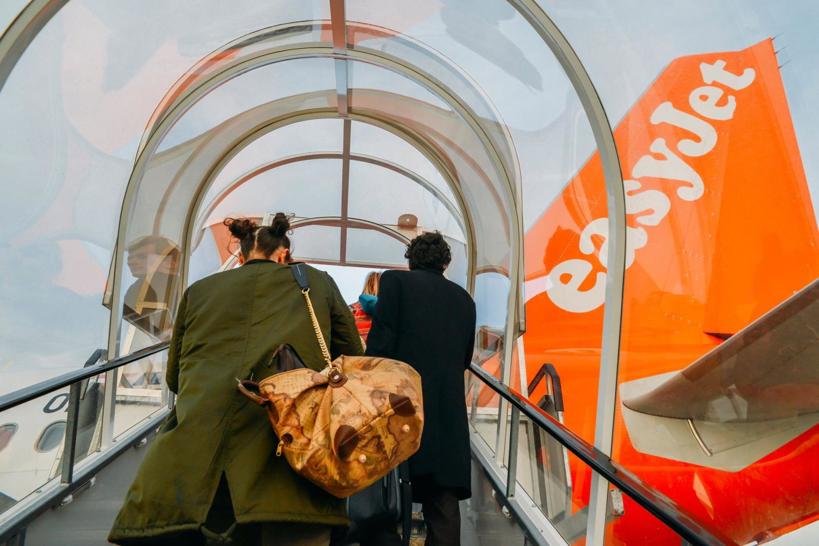 Passengers board an easyJet aircraft