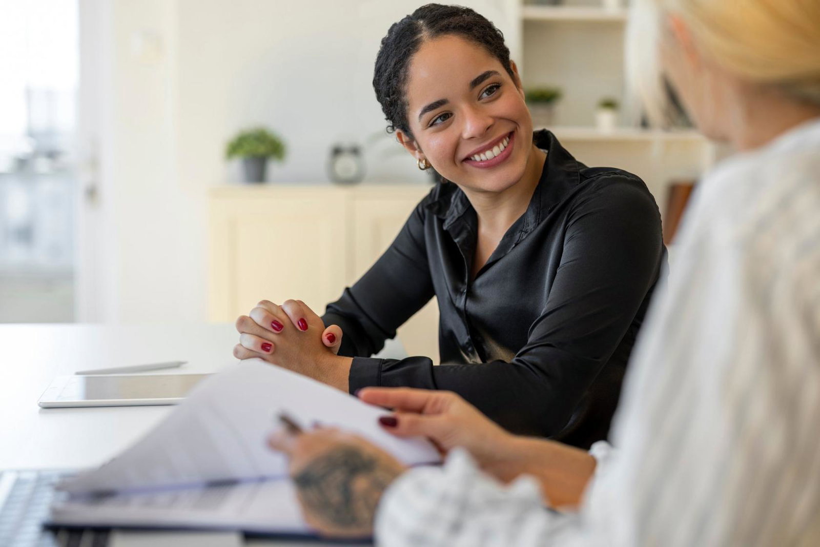 A job candidate pictured smiling with an HR manager