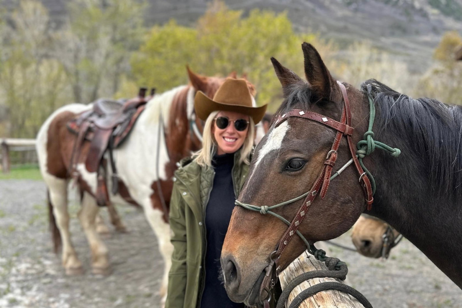 Blonde woman smiling with horse