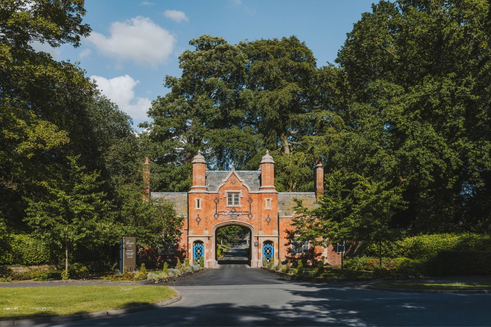 Wide shot of entrance to luxurious red brick hotel in England 