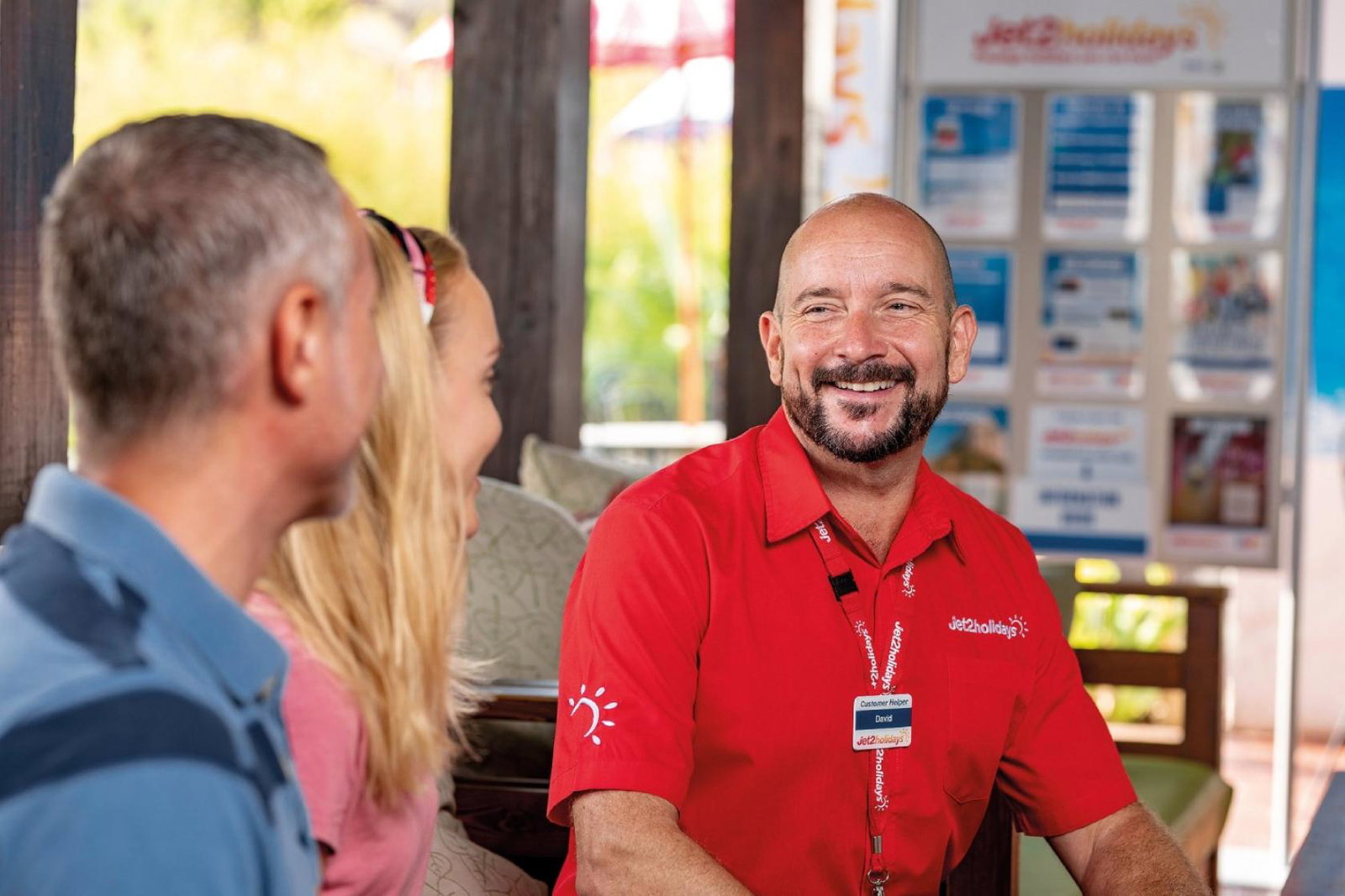 A member of Jet2 check-in staff assists passengers