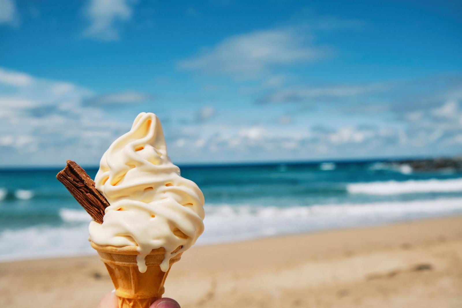 A person holding an ice cream on a UK beach