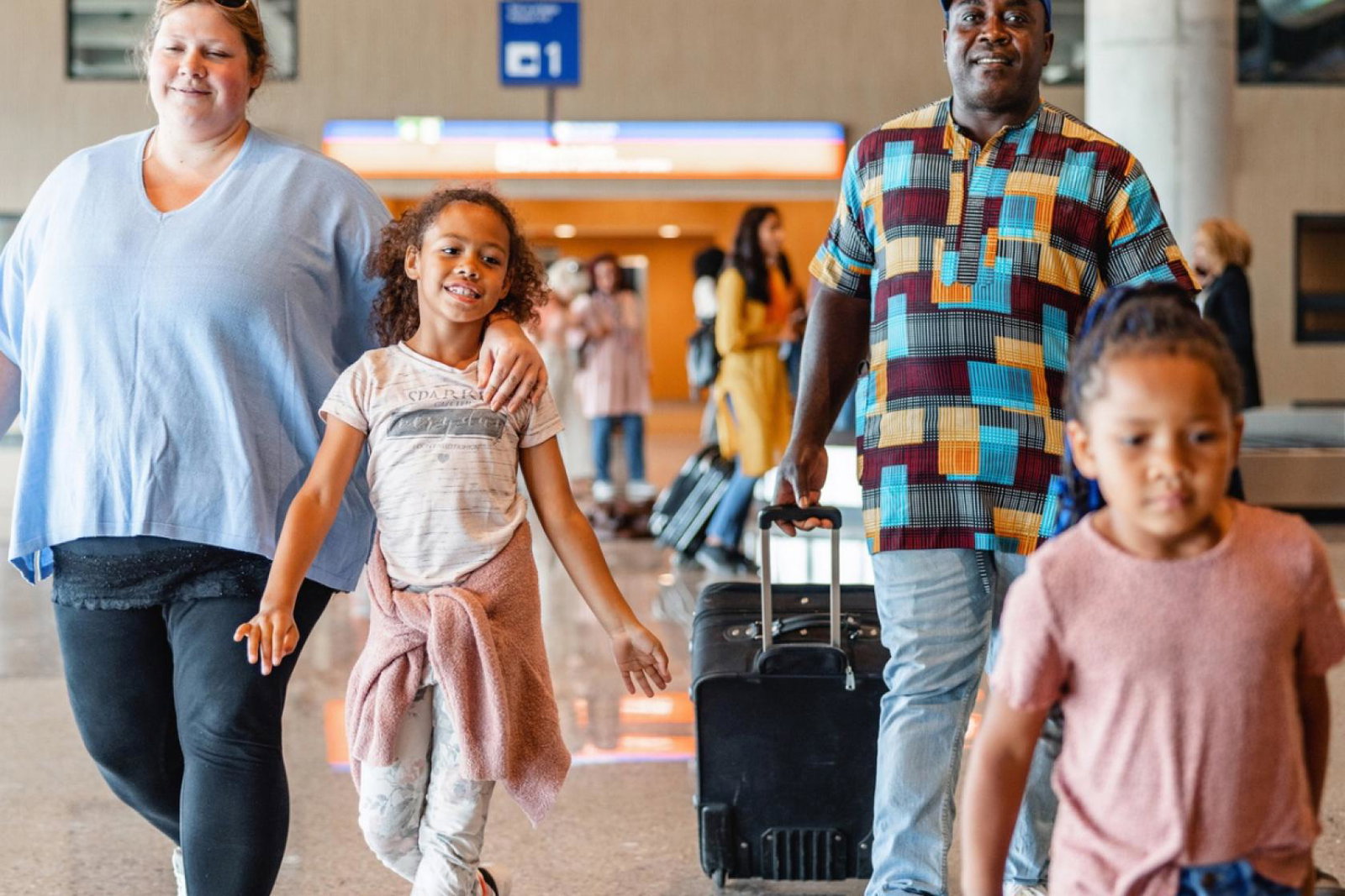 Family walking through airport 