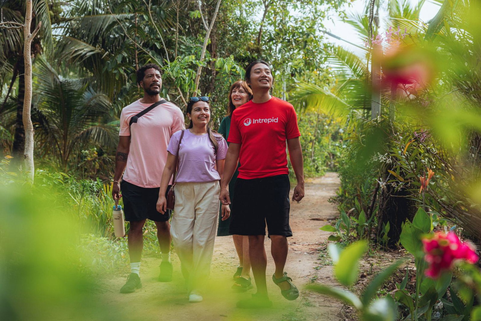 Three Intrepid travellers walking through a forest in Vietnam, led by a local tour leader. Vietnam is one of the company’s top three most popular destinations in September.