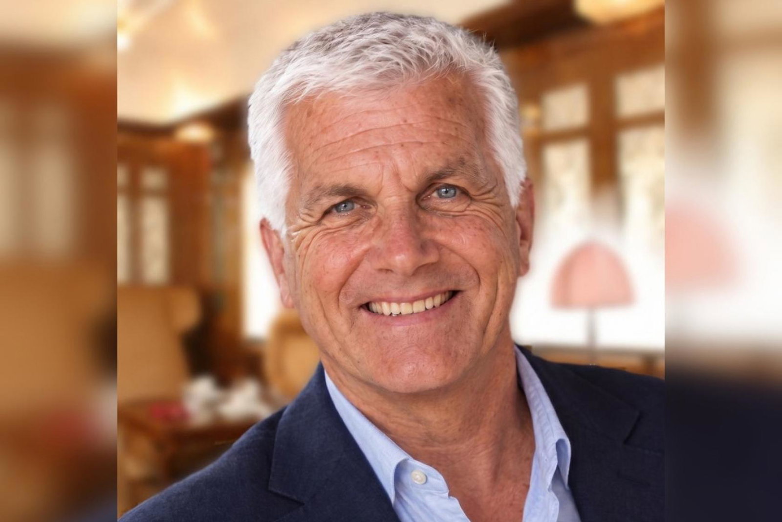 Professional photo of white man smiling with short white hair 