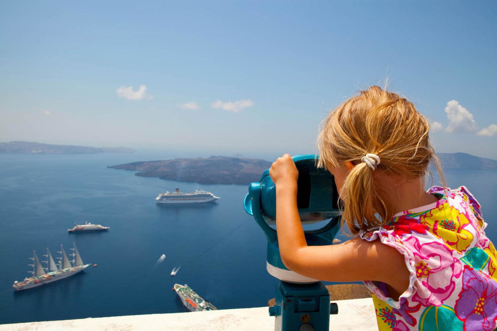 Girl looking at cruise ships (stock)
