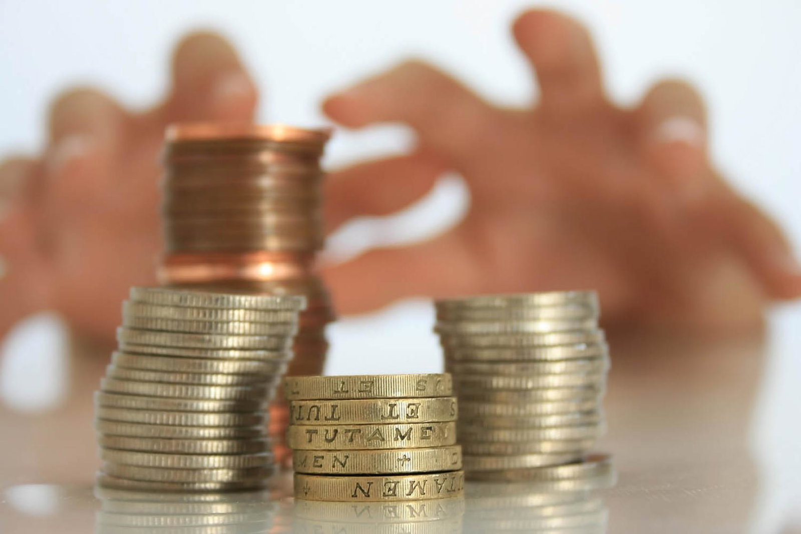Tax - reaching for coins (stock)