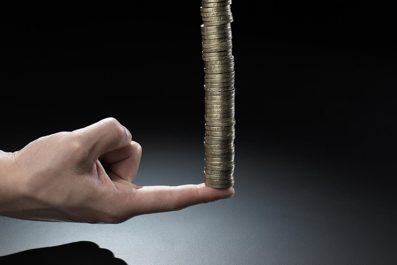 Growth concept - stack of coins on a finger (stock)