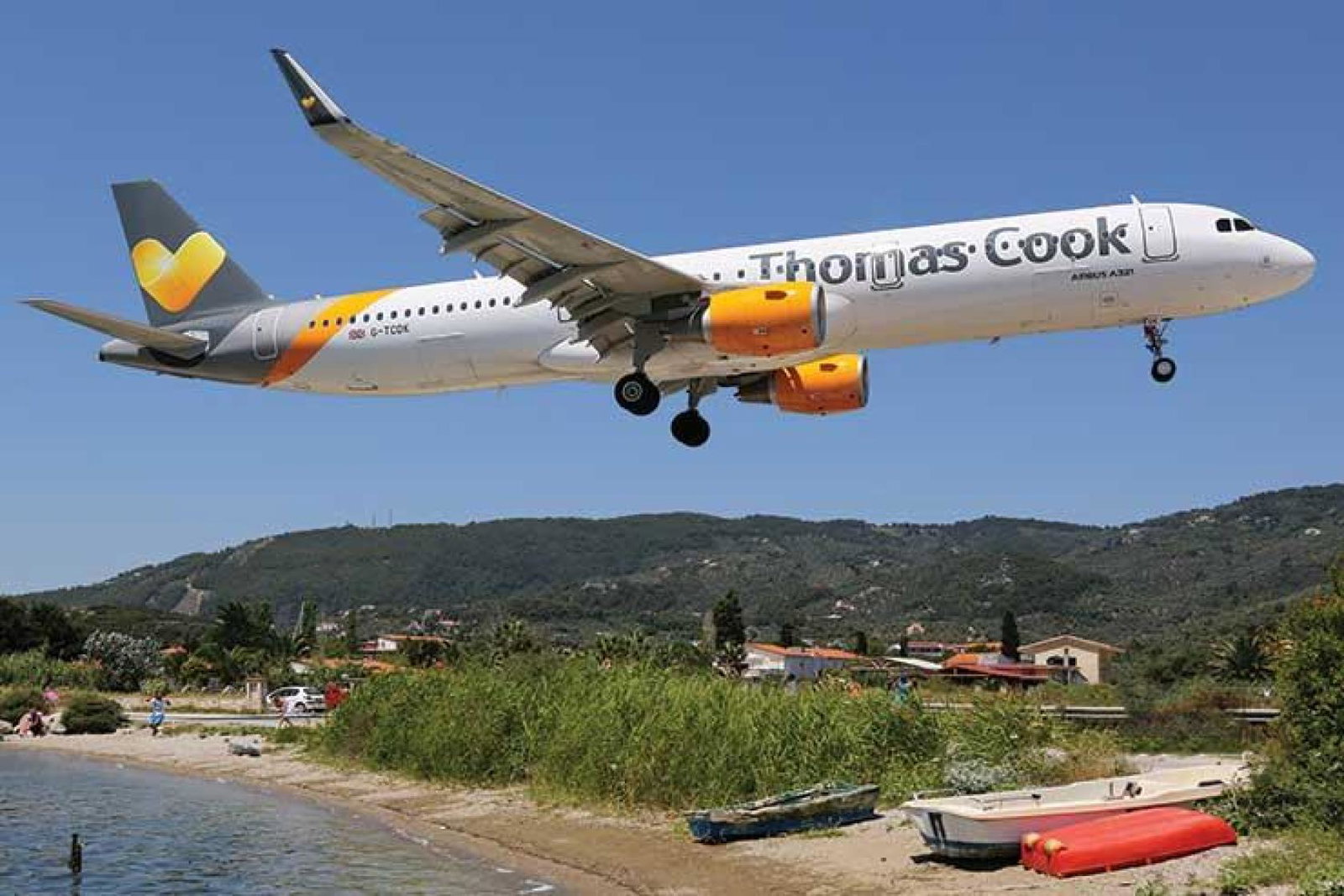 Thomas Cook jet coming in to land over beach iStock-518679572