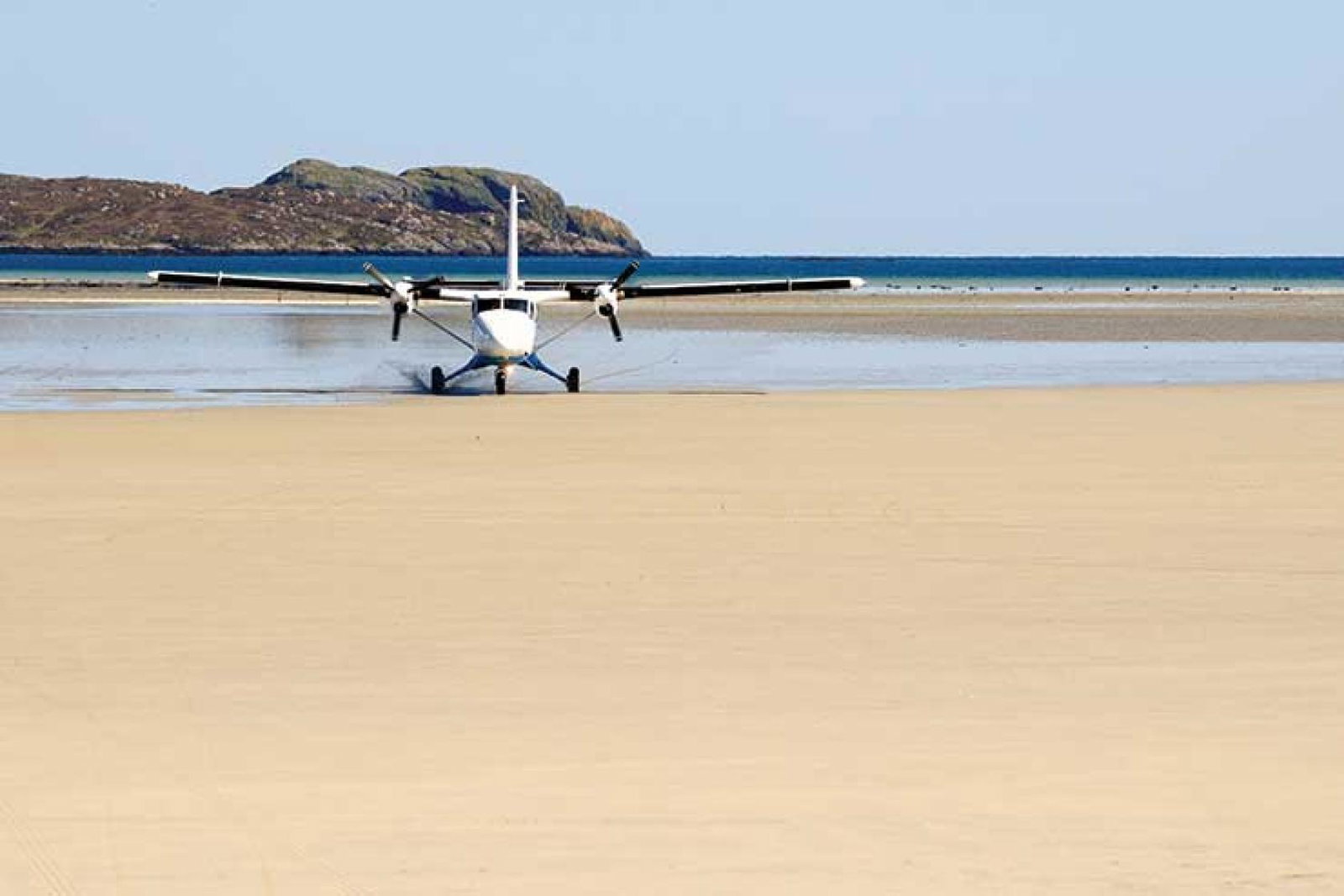 Light aircraft landing on beach iStock-174798675
