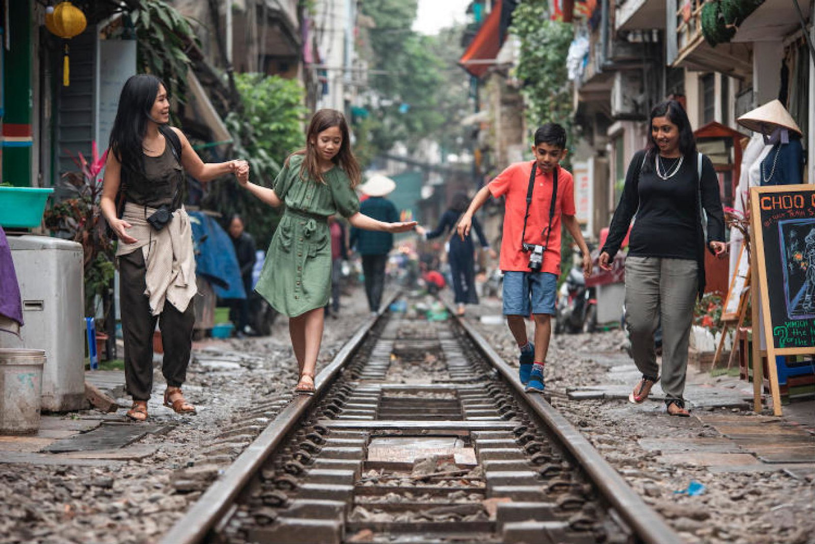 G Adventures National Geographic Vietnam Hanoi Train Street Mothers Children Walking.jpg
