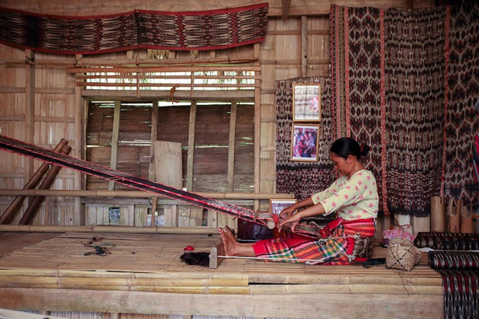 Filipina woman weaving on a loom
