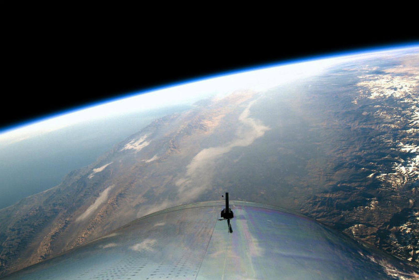 The former boss of Virgin Galactic says the cost of space tourism "will not come down for quite a while yet"