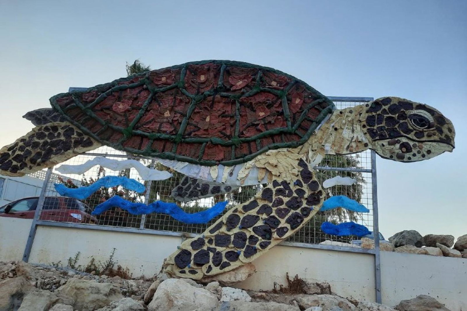 Made entirely from plastic waste, the turtle artwork, named "Calypso", is in a "prominent" position at Ayia Triada beach to raise awareness of the issue of plastic pollution