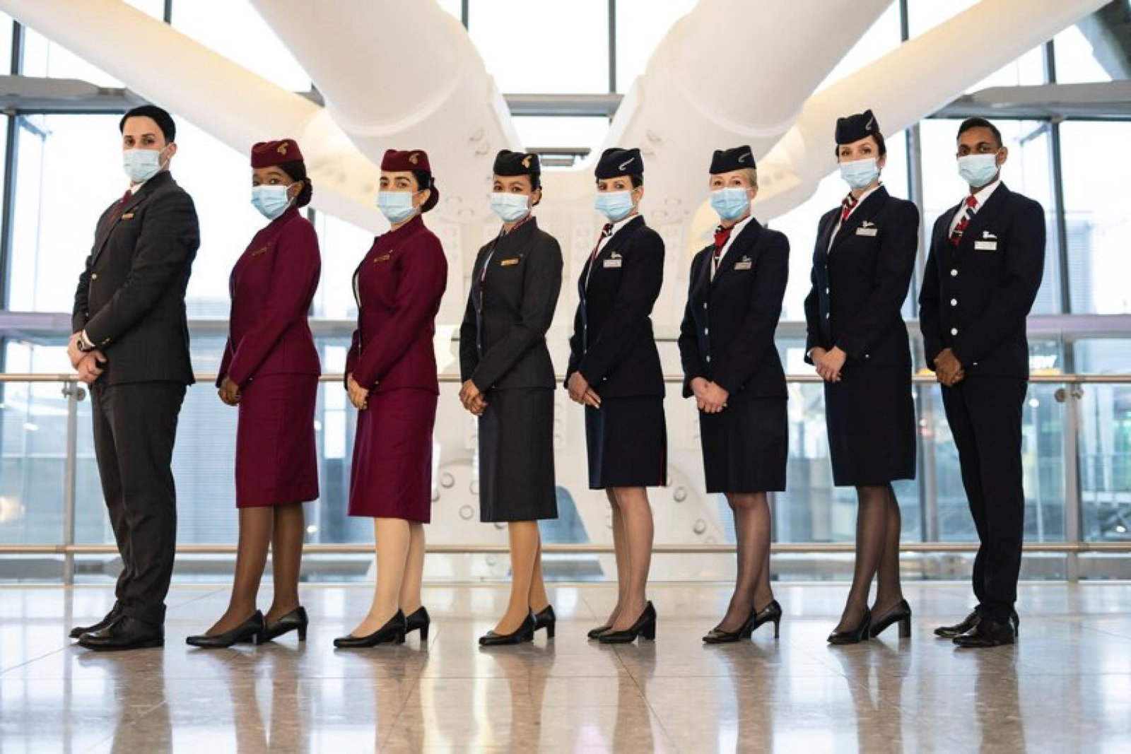 Cabin crew from British Airways and Qatar Airways celebrate plans to expand the two carriers' joint business