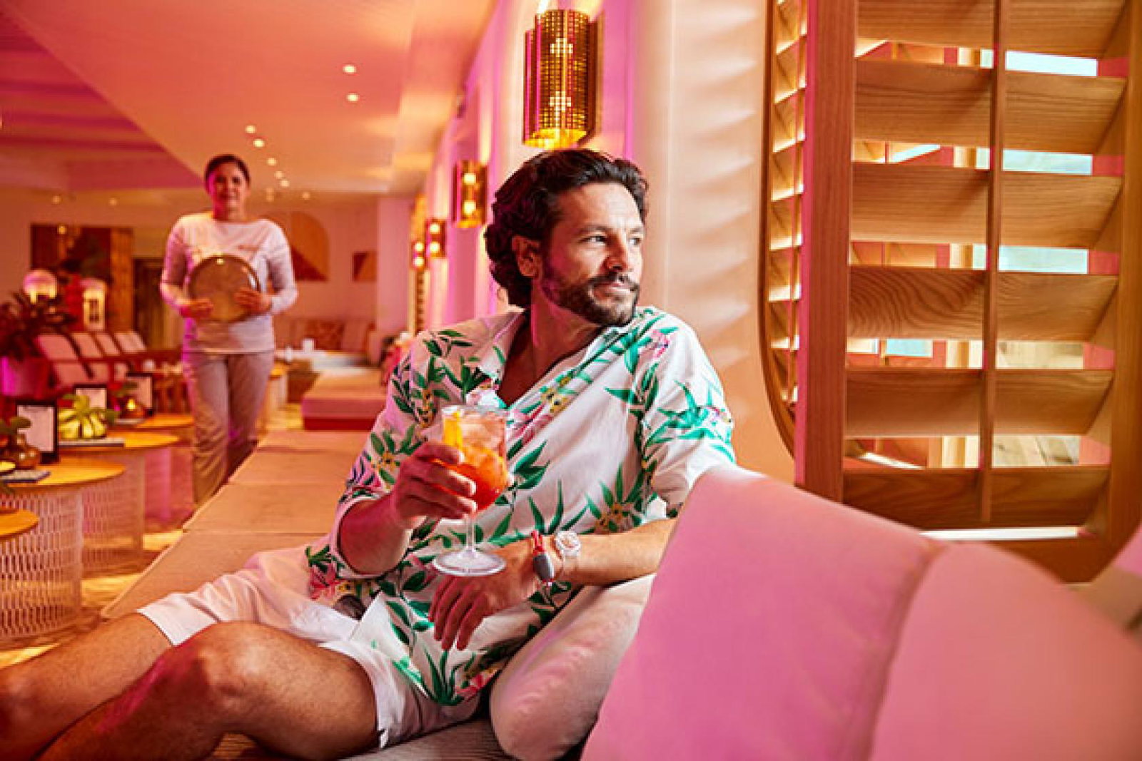 Guest relaxing in the Dock House onboard with Virgin Voyages