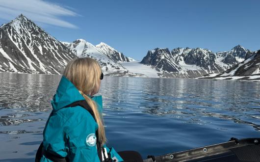 Rebecca Barnes rides on a Zodiac in Svalbard