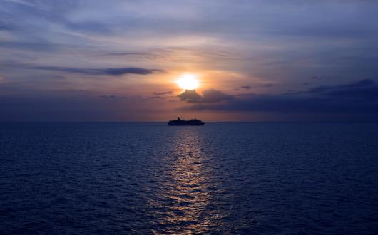 A cruise ship pictured at sea at dusk