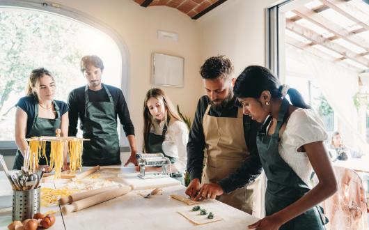 Young travellers pasta making class in Italy