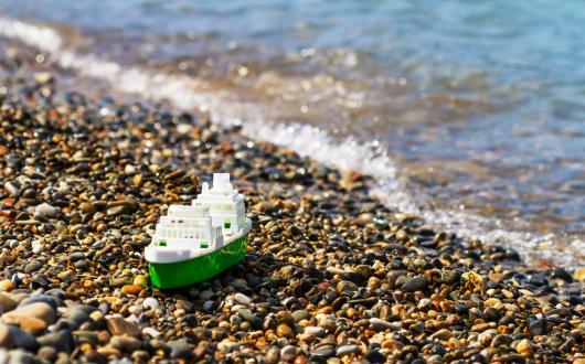 A small plastic ship on the shore