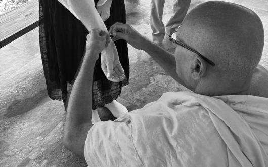 Caroline being blessed by monk