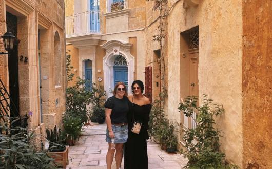 Cerys and colleague post in pretty street in Malta