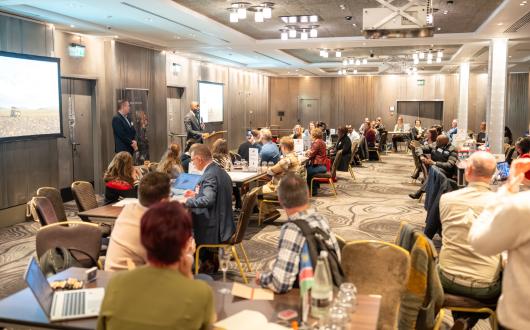 Travel agents sitting around two long tables speaking with Namibia partners at networking event