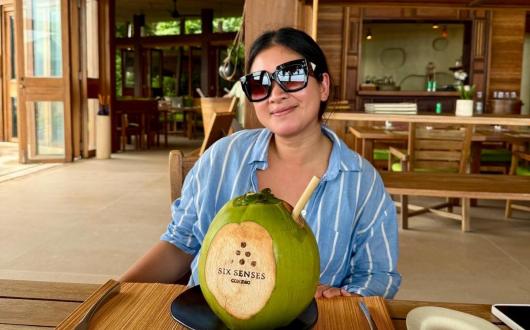 Nong Skett drinking from a coconut