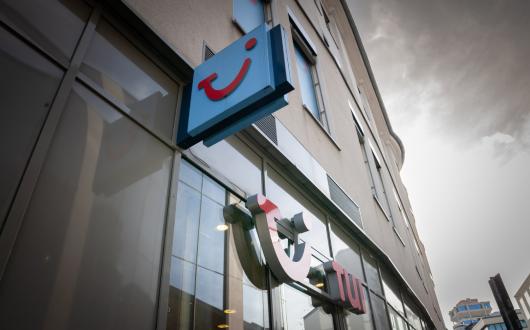 A tui shop pictured with the smile logo on the side of the building