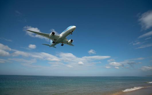 Tui plane flying over beach