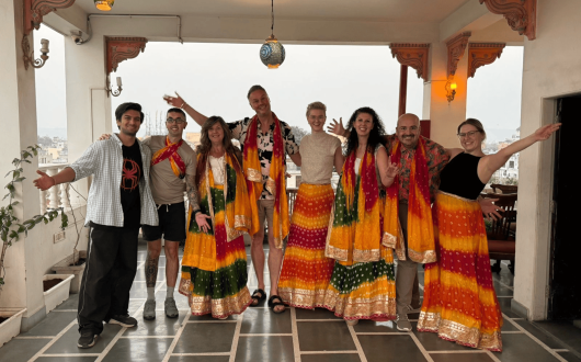 The TTG Travel Ambassadors smile at the camera wearing traditional Bollywood skirts and scarfs 